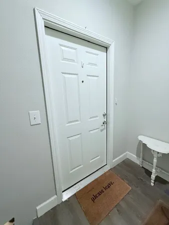 a kitchen with a refrigerator and white cabinets