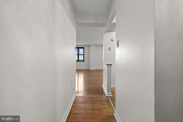 1101 St Paul Street, Unit 710 Baltimore, MD 21202 - Photo 11 of 21 a view of a hallway with wooden floor