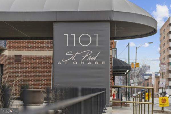 1101 St Paul Street, Unit 710 Baltimore, MD 21202 - Photo 18 of 21 a brick building with a sign on it