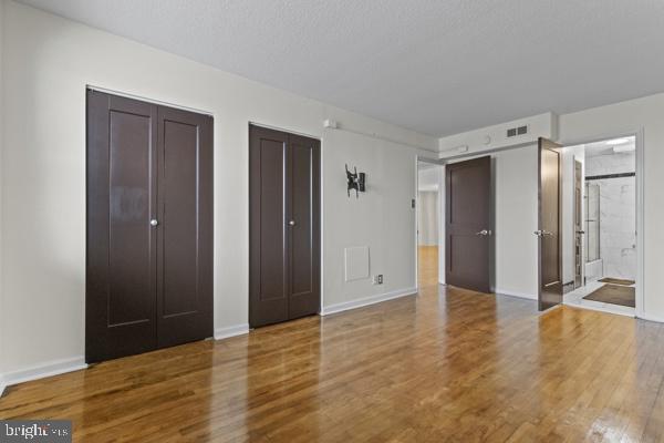 1101 St Paul Street, Unit 710 Baltimore, MD 21202 - Photo 2 of 21 a view of livingroom with walk in closet and wooden floor