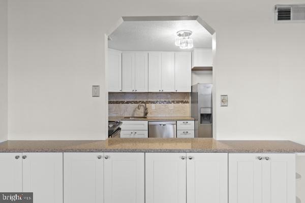 1101 St Paul Street, Unit 710 Baltimore, MD 21202 - Photo 5 of 21 a kitchen with stainless steel appliances granite countertop a sink and cabinets