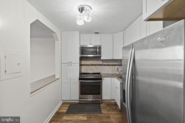1101 St Paul Street, Unit 710 Baltimore, MD 21202 - Photo 9 of 21 a kitchen with stainless steel appliances a refrigerator and a stove top oven