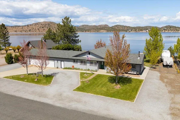 an aerial view of a house with swimming pool garden and patio