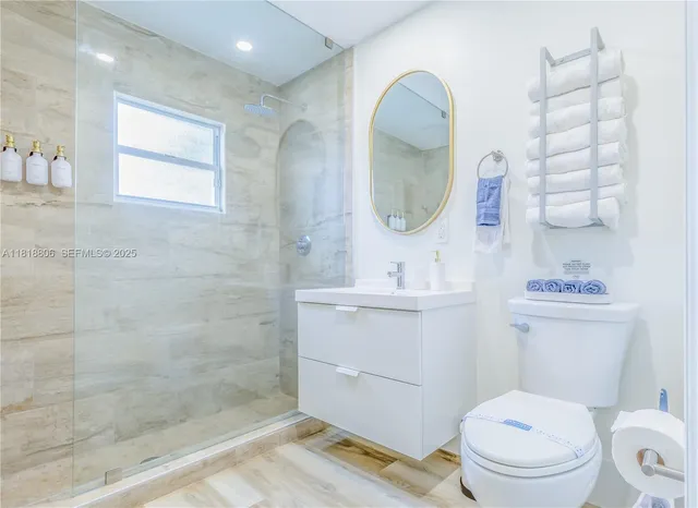 a bathroom with a toilet a sink and mirror