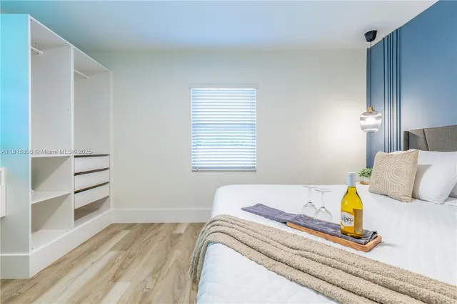 a bedroom with a bed and cabinets