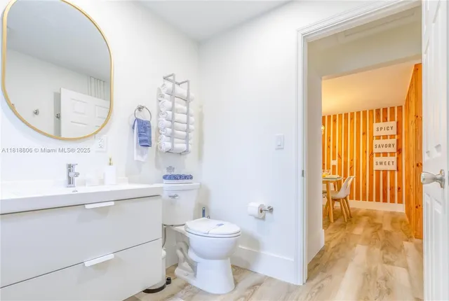 a bathroom with a toilet a sink and a mirror