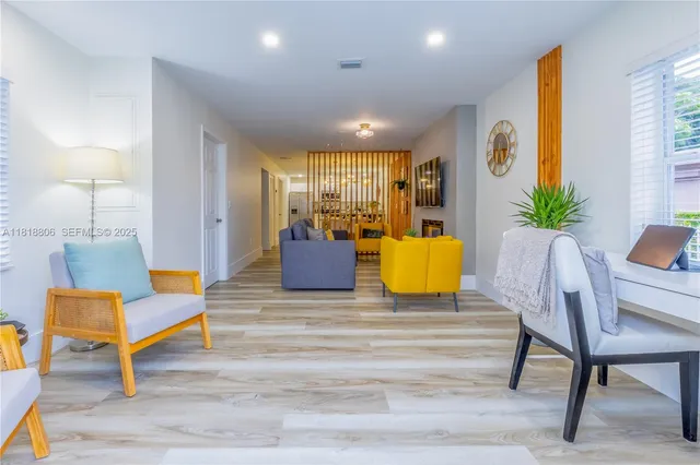 a living room with furniture and wooden floor