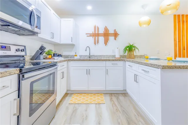 a kitchen with appliances cabinets and a sink