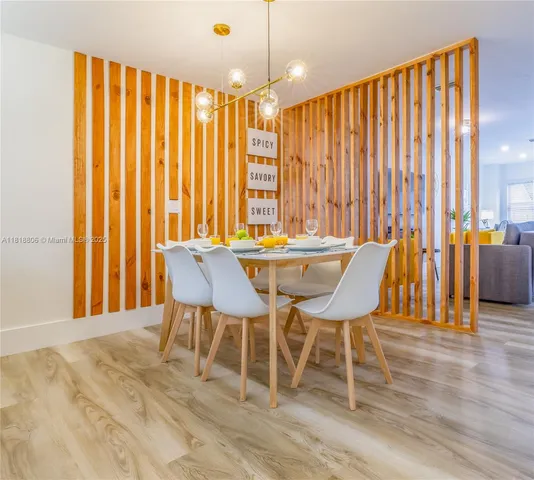 a dining room with furniture and wooden floor