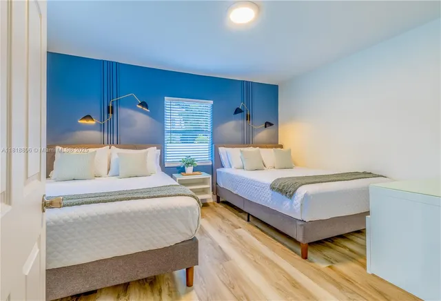 a bedroom with a bed and a potted plant