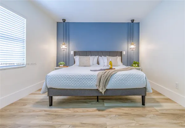a bedroom with a bed and window