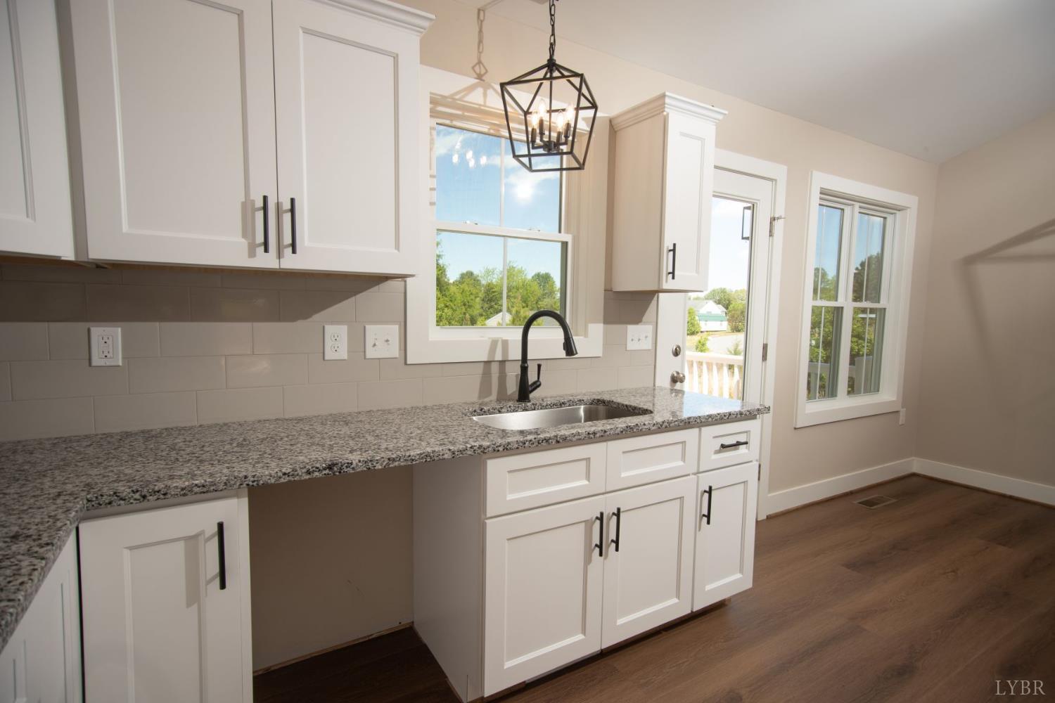 108 Montfair Drive Amherst, VA 24521 - Photo 12 of 39 a kitchen with stainless steel appliances granite countertop white cabinets sink and window
