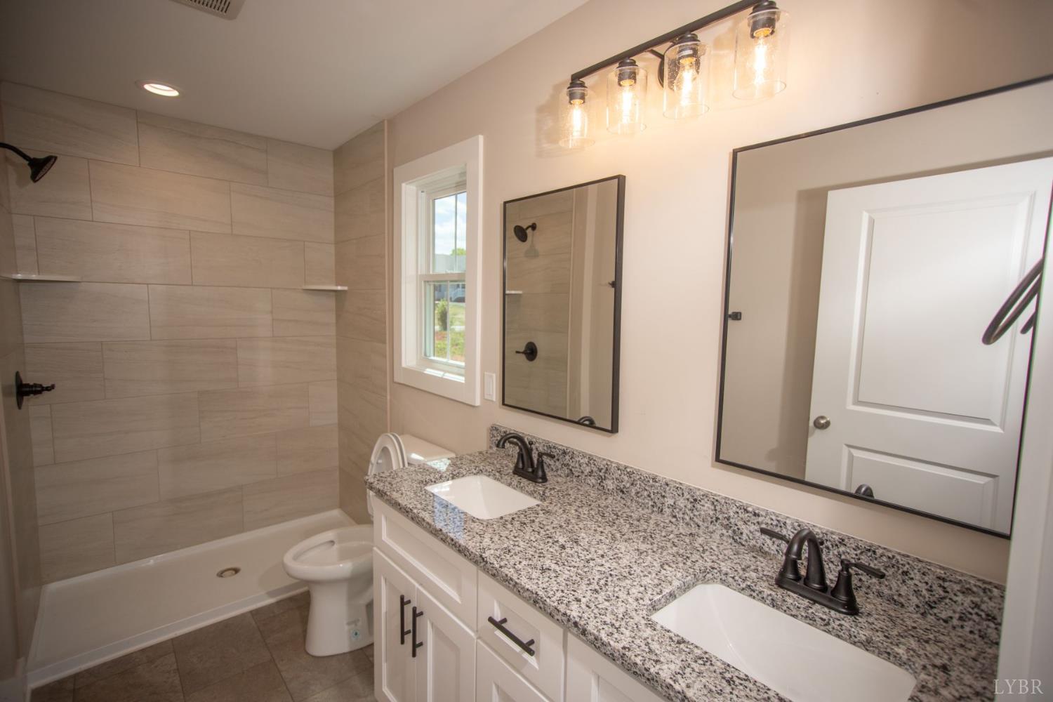 108 Montfair Drive Amherst, VA 24521 - Photo 14 of 39 a bathroom with a granite countertop sink toilet and shower