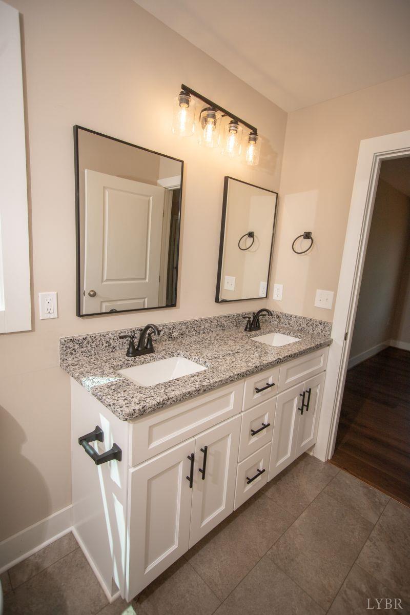 108 Montfair Drive Amherst, VA 24521 - Photo 16 of 39 a bathroom with a granite countertop sink and a mirror
