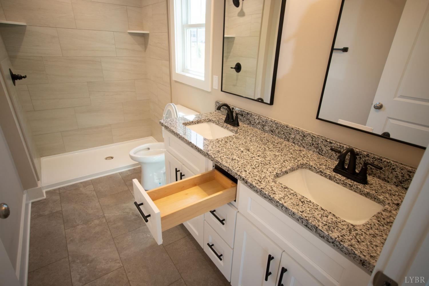108 Montfair Drive Amherst, VA 24521 - Photo 18 of 39 a bathroom with a granite countertop sink a mirror and a bathtub