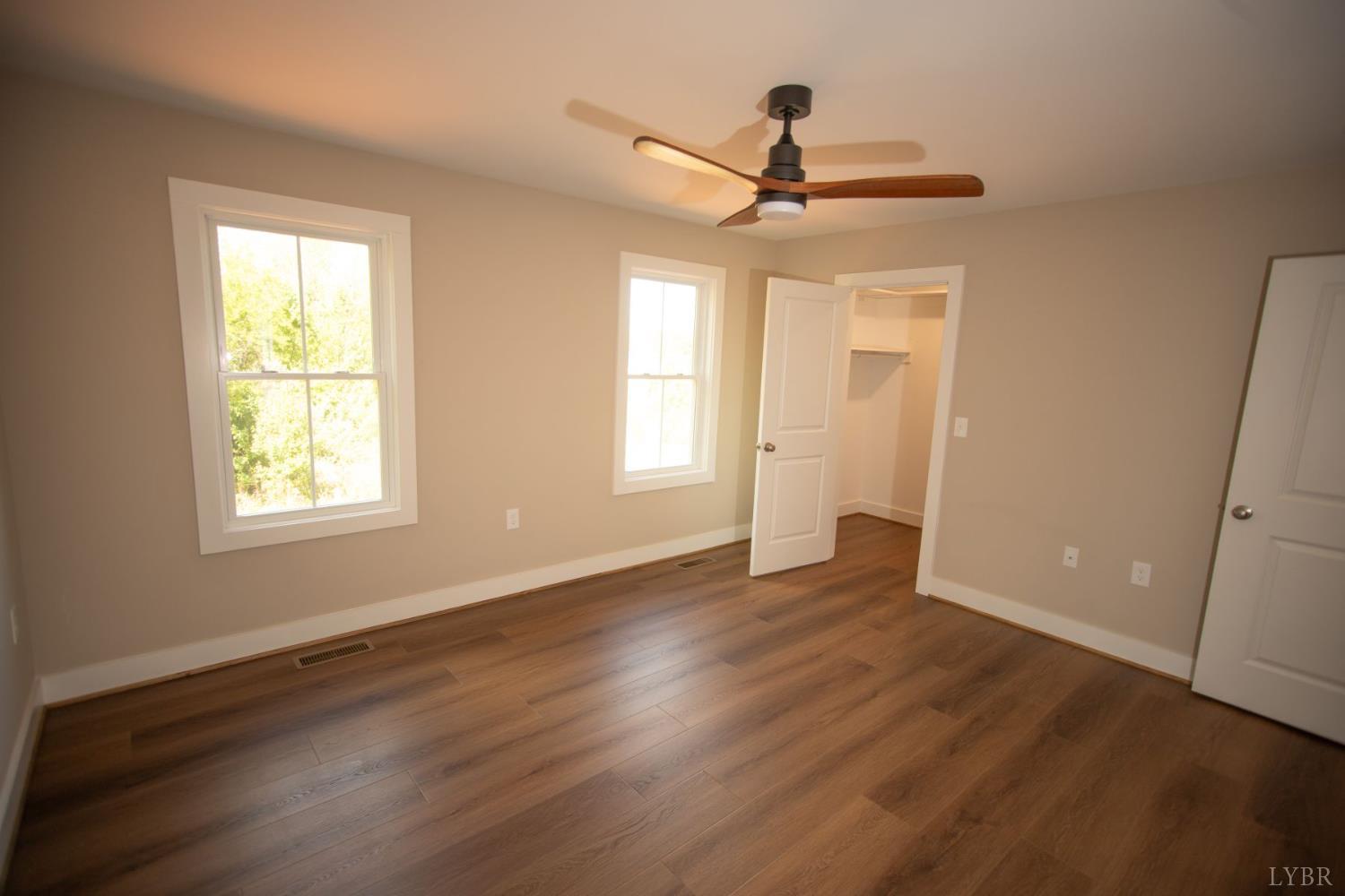 108 Montfair Drive Amherst, VA 24521 - Photo 19 of 39 a view of empty room with wooden floor and fan