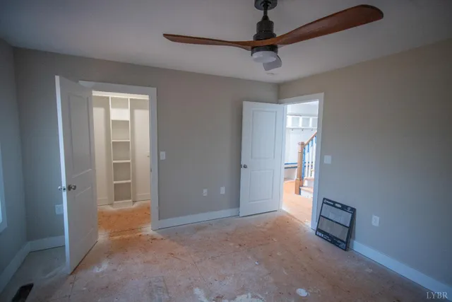 a bathroom with a sink and chandelier fan