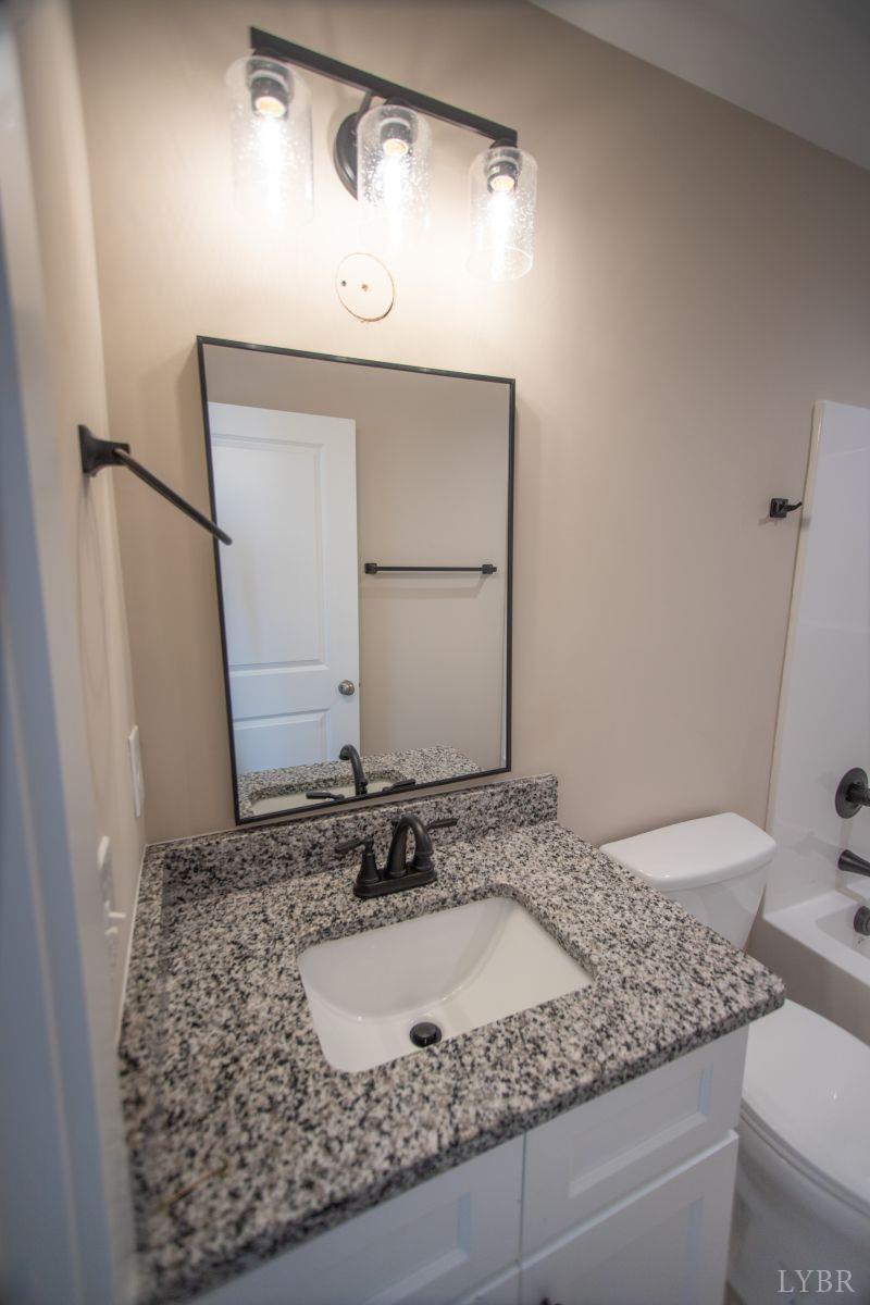 108 Montfair Drive Amherst, VA 24521 - Photo 22 of 39 a bathroom with a granite countertop sink and a mirror