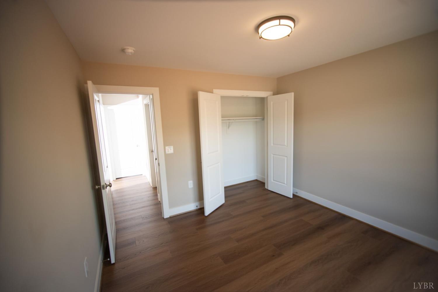 108 Montfair Drive Amherst, VA 24521 - Photo 23 of 39 an empty room with wooden floor and window