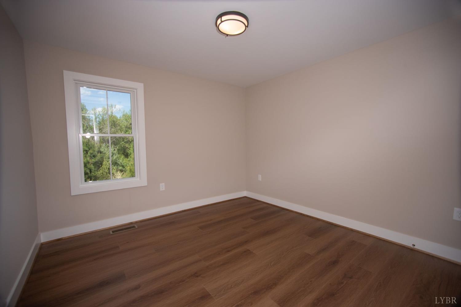108 Montfair Drive Amherst, VA 24521 - Photo 25 of 39 an empty room with wooden floor and windows