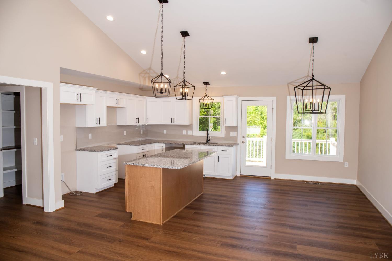 108 Montfair Drive Amherst, VA 24521 - Photo 5 of 39 a large kitchen with kitchen island a stove a sink a center island and a wooden floor