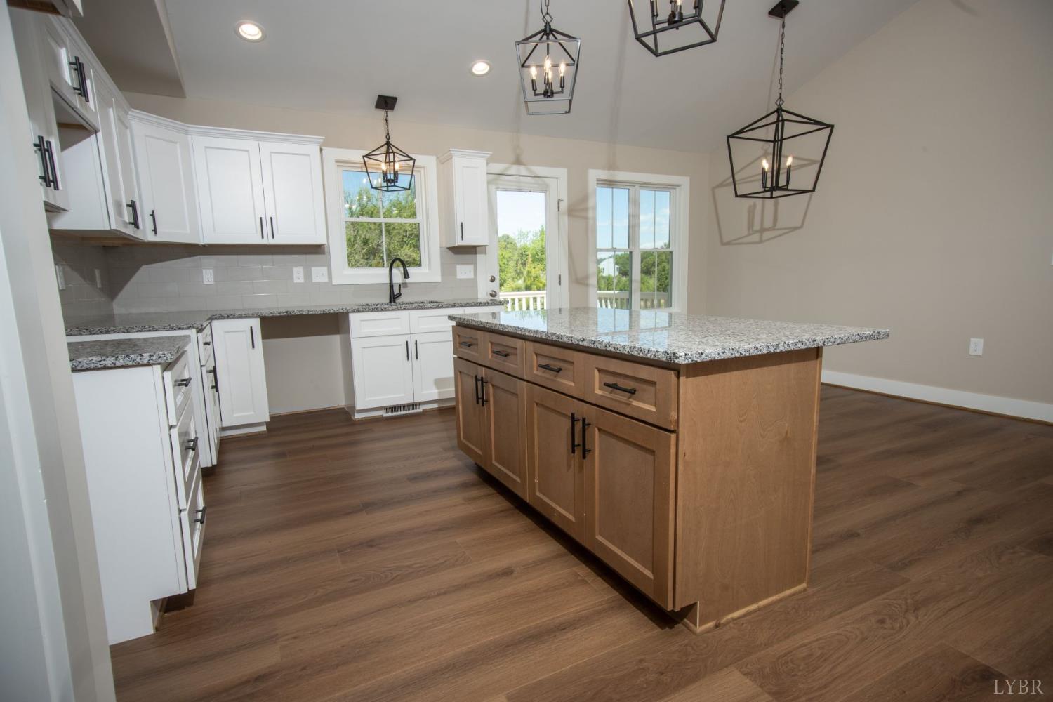 108 Montfair Drive Amherst, VA 24521 - Photo 7 of 39 a kitchen with kitchen island granite countertop wooden cabinets and white appliances