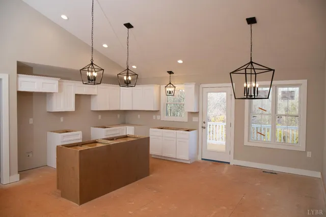 a kitchen with kitchen island a counter top space a sink and appliances
