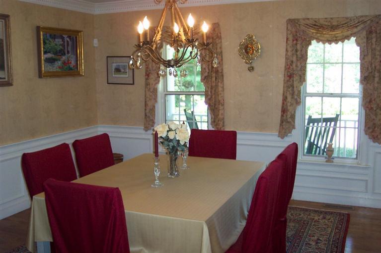 45 Bumps River Road Osterville, MA 02655 - Photo 11 of 21 a view of a dining room with furniture a chandelier and wooden floor