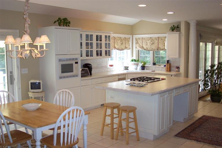 45 Bumps River Road Osterville, MA 02655 - Photo 4 of 21 a kitchen with stainless steel appliances granite countertop a stove a kitchen island a table and chairs in it