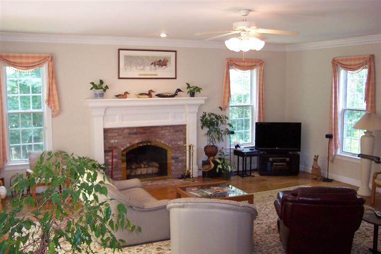 45 Bumps River Road Osterville, MA 02655 - Photo 8 of 21 a living room with furniture a fireplace and a flat screen tv