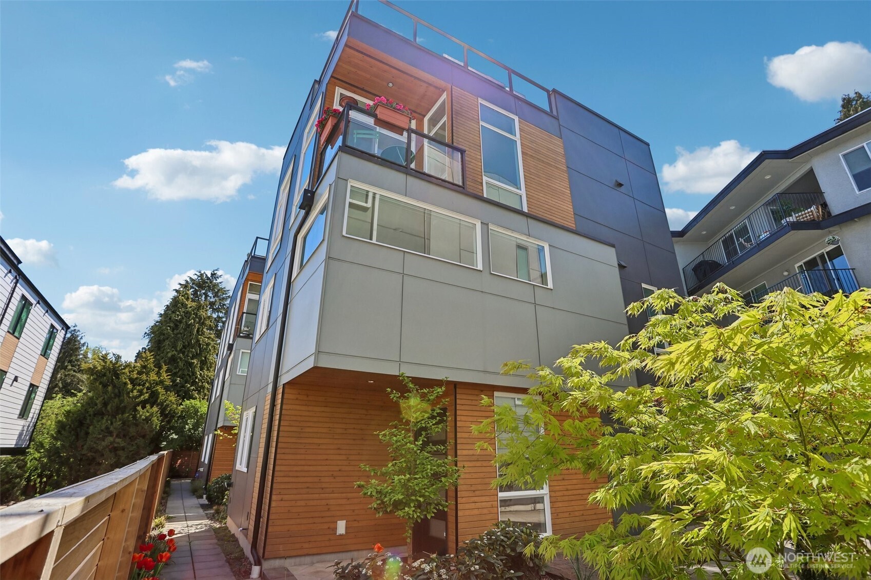 1926 Ferry Avenue Southwest Seattle, WA 98116 - Photo 1 of 40 a blue building with trees in front of it