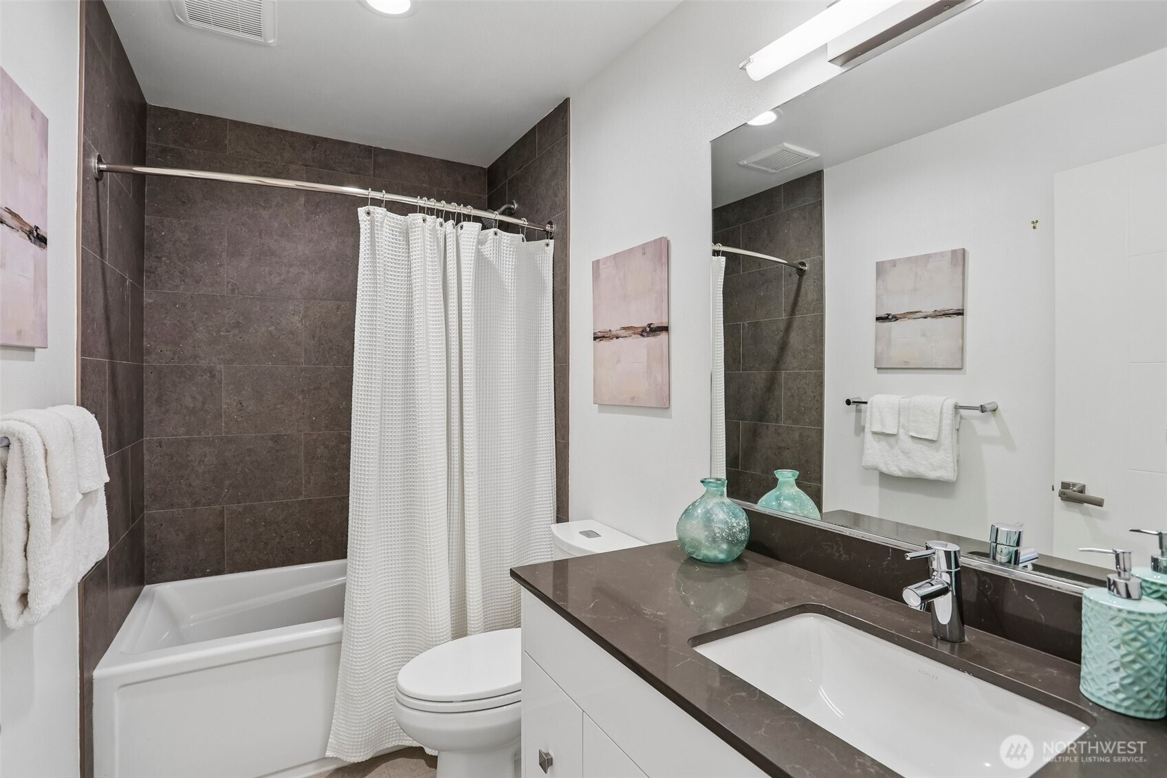 1926 Ferry Avenue Southwest Seattle, WA 98116 - Photo 25 of 40 a bathroom with a granite countertop sink toilet a mirror a vanity and shower