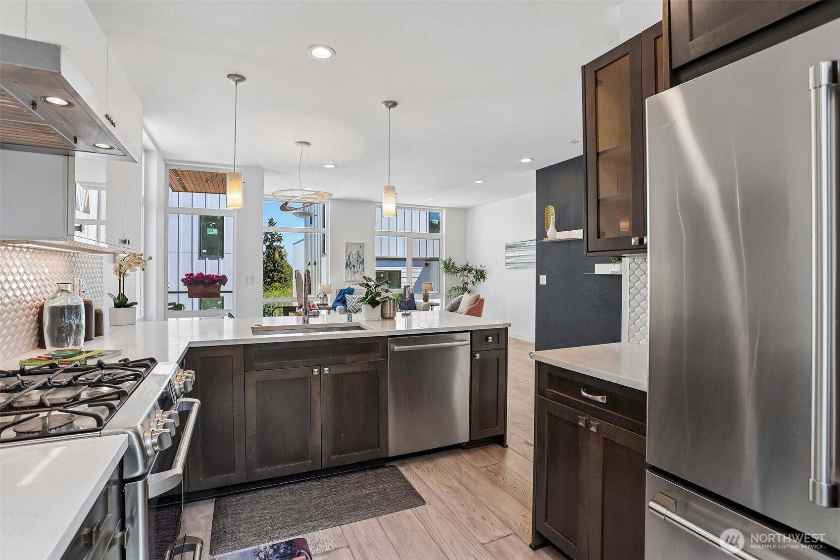 1926 Ferry Avenue Southwest Seattle, WA 98116 - Photo 4 of 40 a kitchen with stainless steel appliances a refrigerator sink and stove