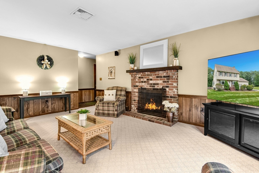 36 Turner Street Norfolk, MA 02056 - Photo 12 of 41 a living room with furniture and a fireplace