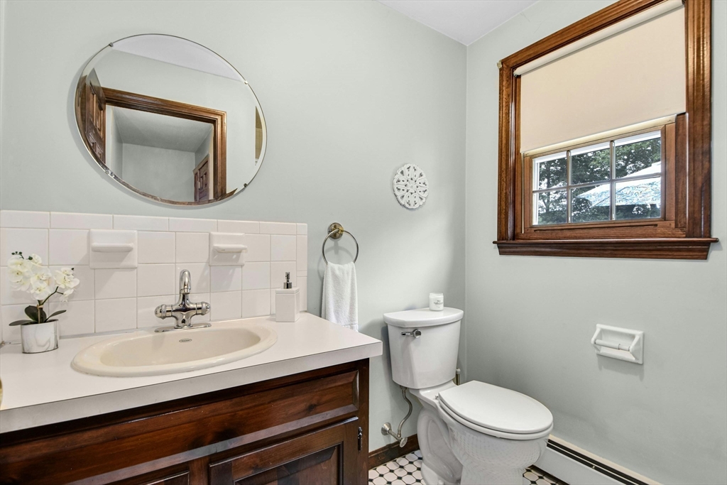 36 Turner Street Norfolk, MA 02056 - Photo 13 of 41 a bathroom with a toilet a sink and mirror