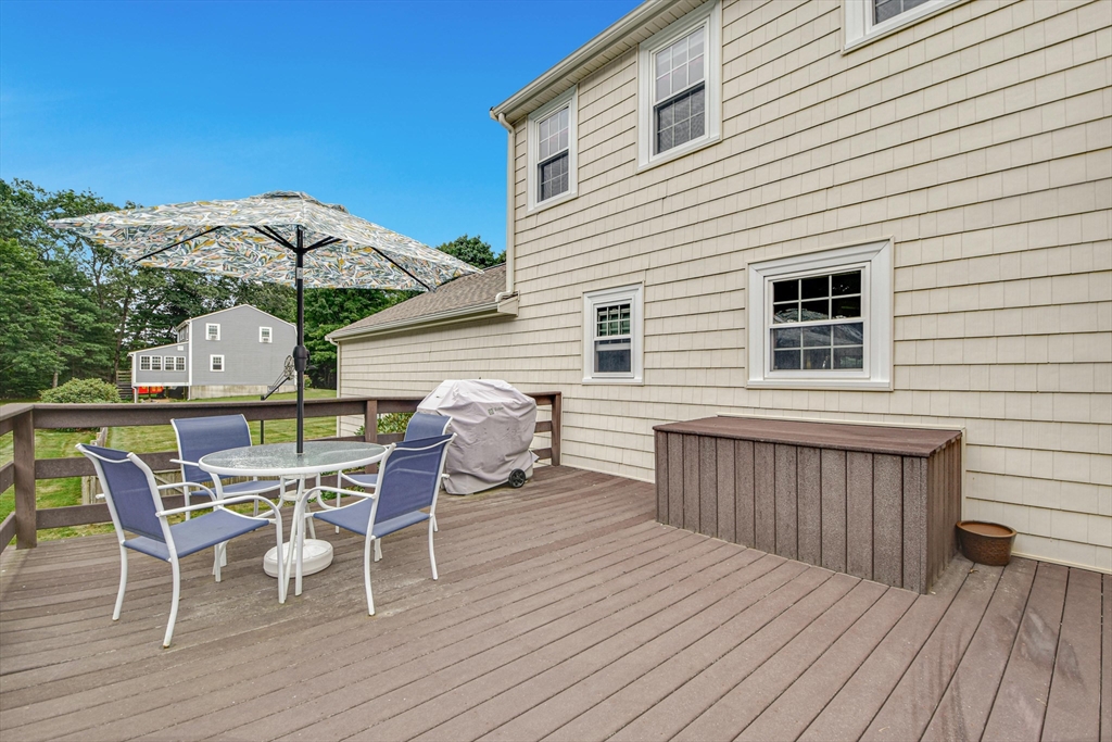 36 Turner Street Norfolk, MA 02056 - Photo 24 of 41 a view of a roof deck with table and chairs and wooden floor