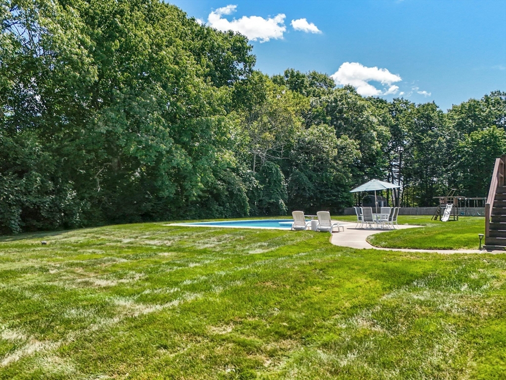36 Turner Street Norfolk, MA 02056 - Photo 34 of 41 a view of a swimming pool with a fountain and large trees