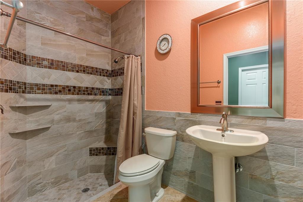 2103 Northwest Marsh Rabbit Lane Stuart, FL 34994 - Photo 11 of 20 a bathroom with a sink toilet and shower