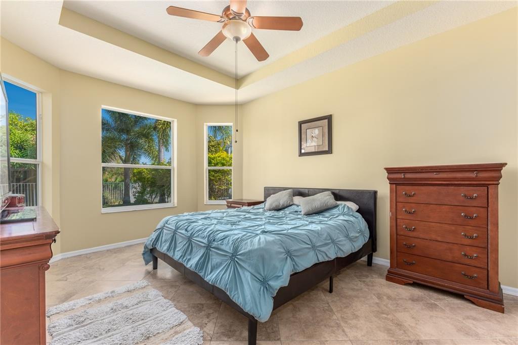 2103 Northwest Marsh Rabbit Lane Stuart, FL 34994 - Photo 12 of 20 a bedroom with a bed a dresser and a window