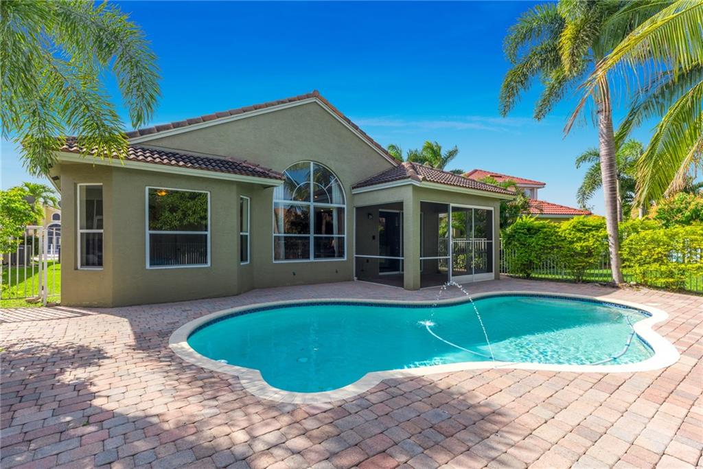 2103 Northwest Marsh Rabbit Lane Stuart, FL 34994 - Photo 2 of 20 a view of a house with a swimming pool and a yard
