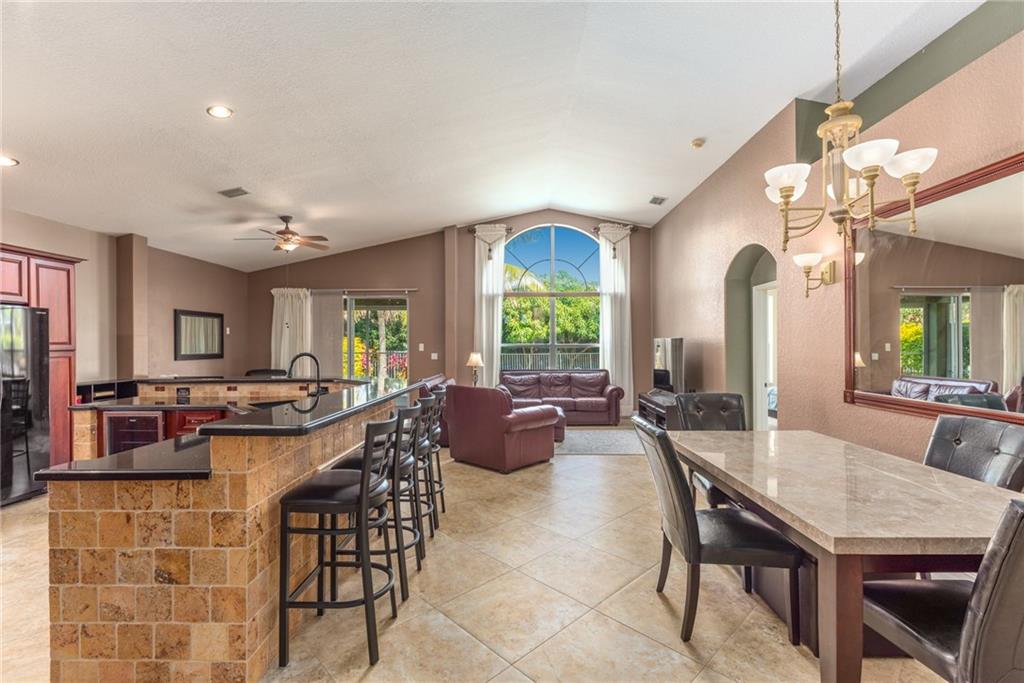 2103 Northwest Marsh Rabbit Lane Stuart, FL 34994 - Photo 6 of 20 a view of a dining room with furniture window and outside view