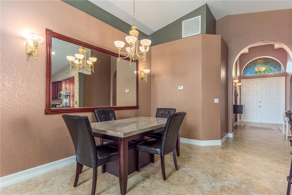 2103 Northwest Marsh Rabbit Lane Stuart, FL 34994 - Photo 10 of 20 a view of a dining room with furniture and a chandelier