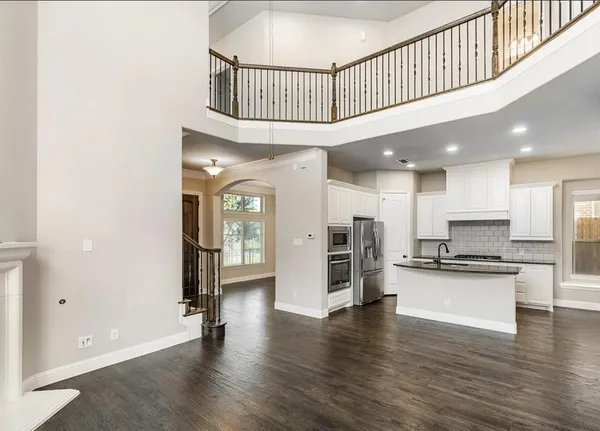 a view of kitchen with stainless steel appliances granite countertop a stove and a refrigerator