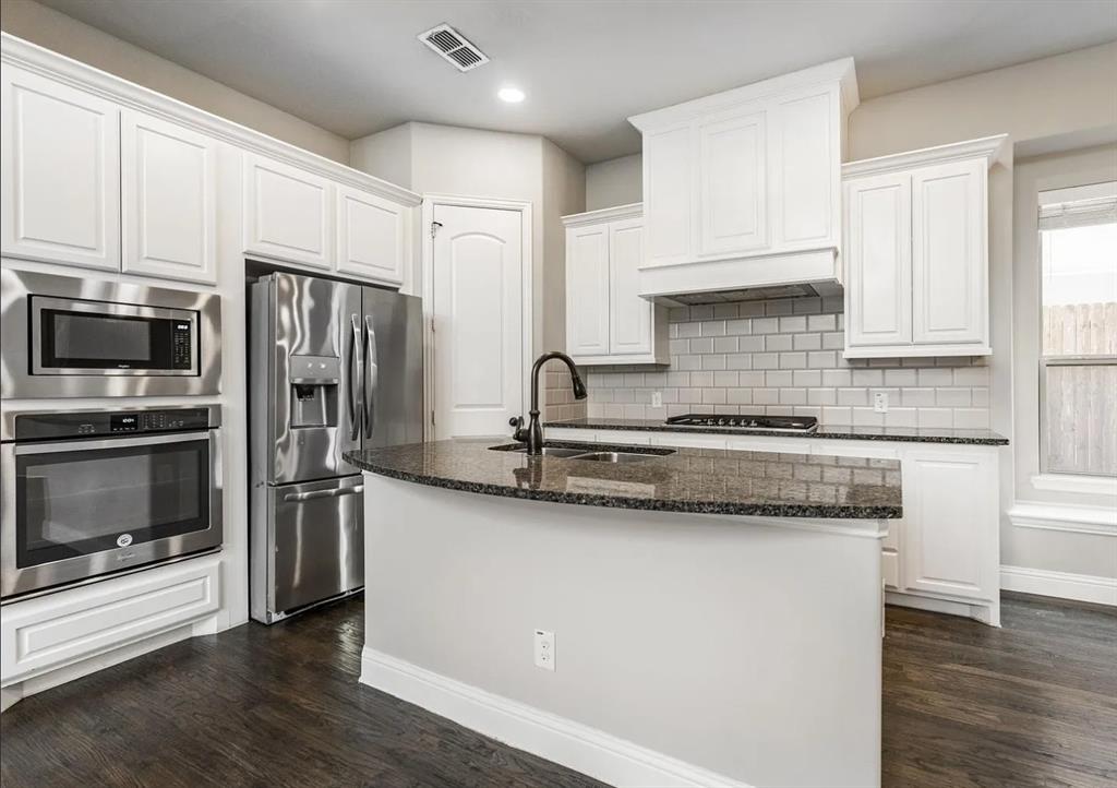 5215 Wakefield Drive Irving, TX 75038 - Photo 14 of 36 a kitchen with stainless steel appliances granite countertop a sink stove and refrigerator