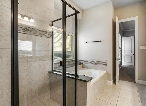 a bathroom with a tub and shower