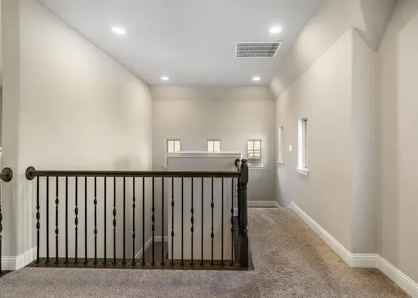 a view of hallway with wooden floor