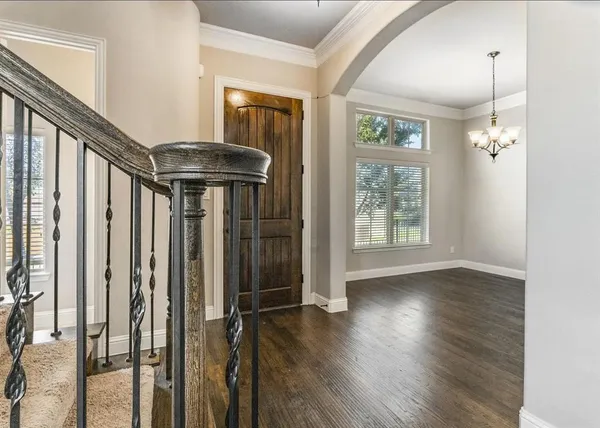 a view of an entryway with wooden floor and door