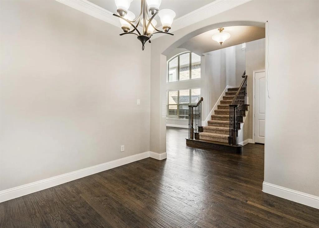 5215 Wakefield Drive Irving, TX 75038 - Photo 7 of 36 an empty room with wooden floor and staircase