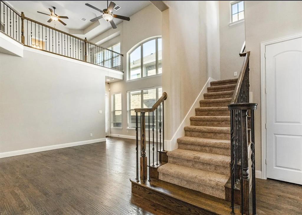 5215 Wakefield Drive Irving, TX 75038 - Photo 10 of 36 a view of staircase with lots of frames and white walls