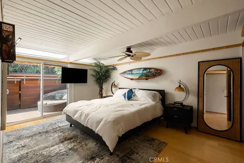 a bathroom with a granite countertop sink a mirror a bathtub and shower
